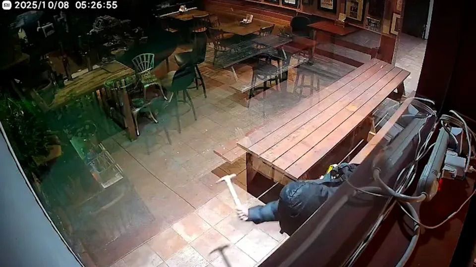 A suspect is seen on video surveillance smashing the windows of Lucky’s Smokehouse twice, once with a hammer and another time with an axe in October 2025.
