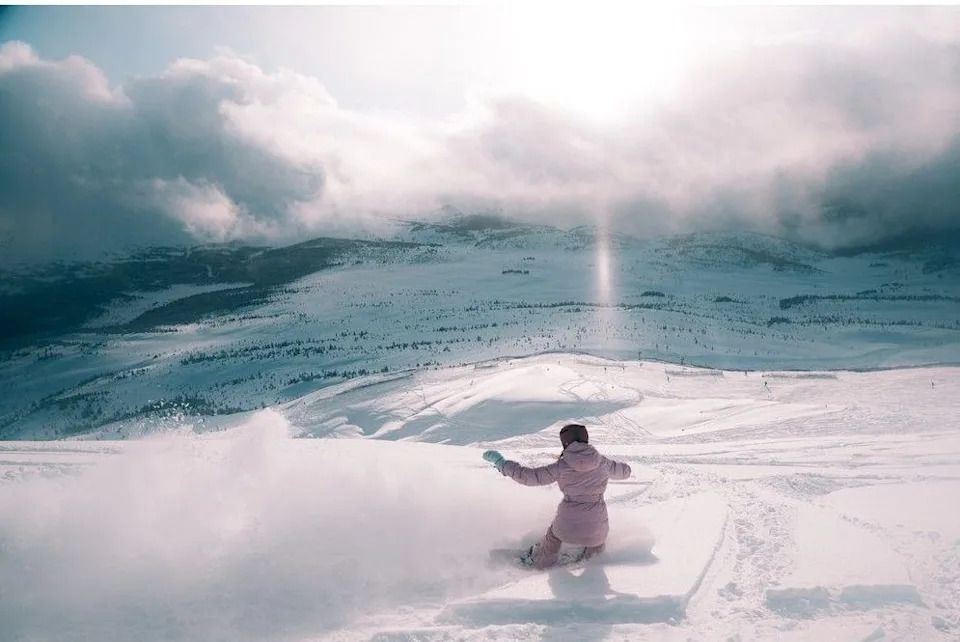 A snowboarder enjoys the deep powder snow on a wide-open run at Sunshine Village. Courtesy, Sunshine Village