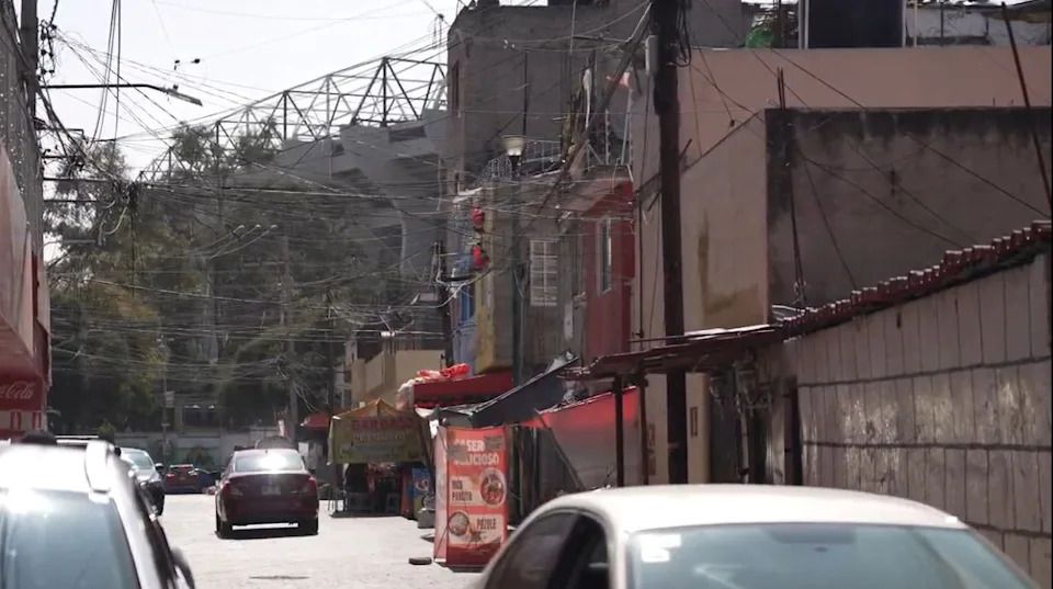 A corner of Azteca Stadium looms over Pueblo de Santa Ursula Coapa.