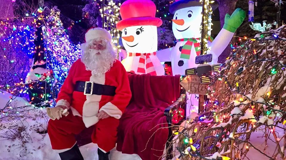 Bev Cuckow (Santa Bevy) surrounded by Christmas lights at his Scenic Acres home.
