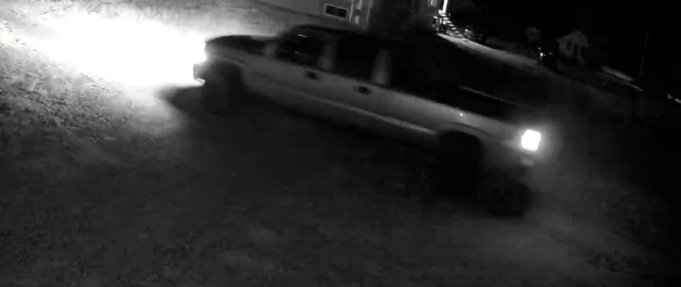 The truck is described as a mid-90’s to early 2000’s light grey/silver lifted pick-up truck.