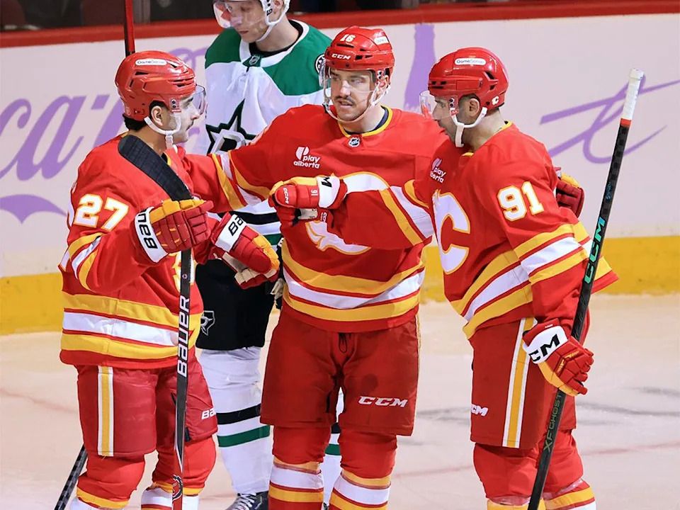 Calgary Flames forwards Matt Coronato, Morgan Frost and Nazem Kadri celebrate Coronato’s goal against the Dallas Stars during NHL action at the Scotiabank Saddledome in Calgary on Saturday, Nov. 22, 2025.