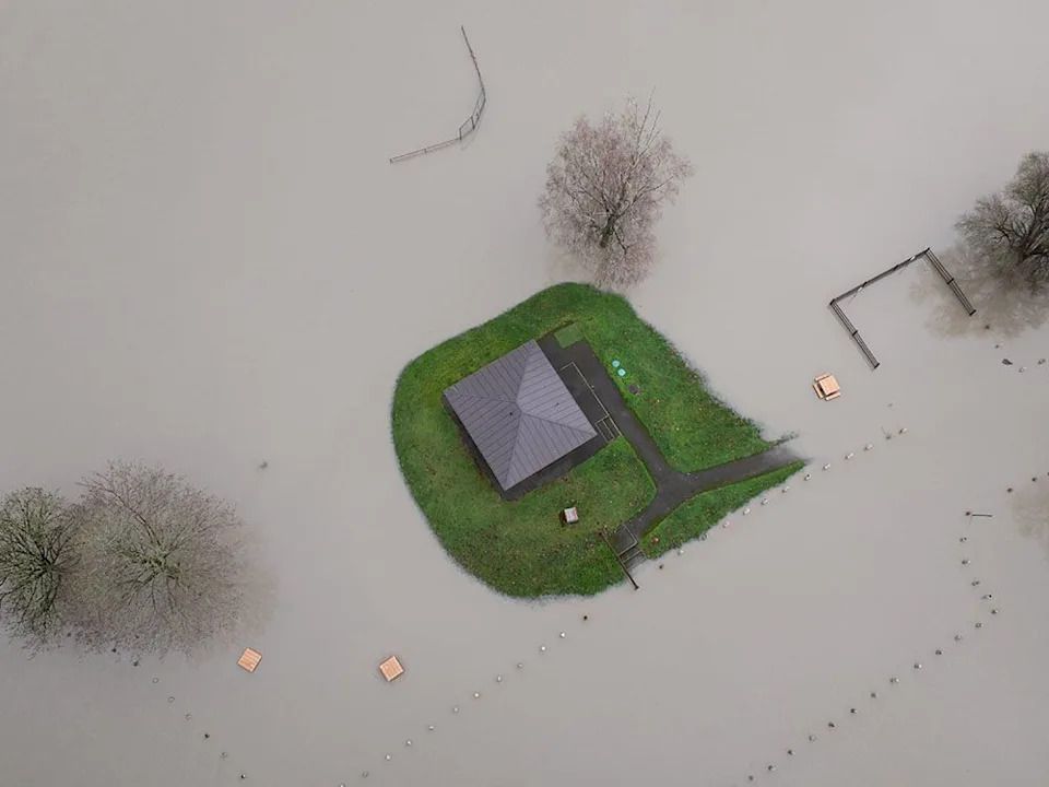 A home is surrounded by floodwaters near Twin Rivers Snohomish County Park in Arlington, Wash., Thursday, Dec. 11, 2025.