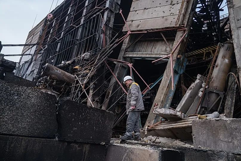 A worker walks in front of a production hall after a recent Russian missile attack at DTEK's power plant in Ukraine, 10 December, 2025