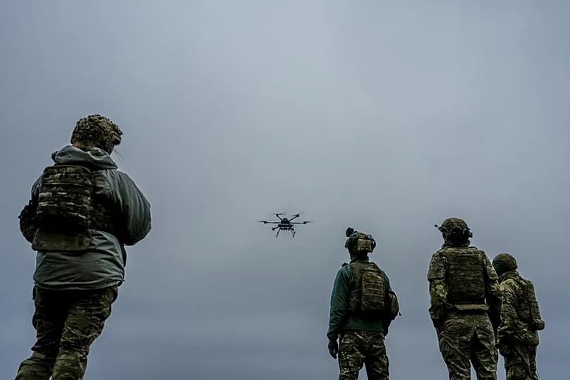 A Ukrainian drone operator from the Kraken 1654 unit, callsign Imla, left, flies a Vampire drone as other soldiers watch in Kharkiv region, Ukraine.