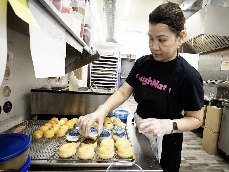 Mary Jane Munoz puts the finishing touches on sufganiyot at DoughNats.