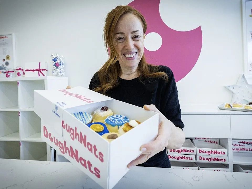 Nathalie Shtern displays a box of sufganiyot at DoughNats.