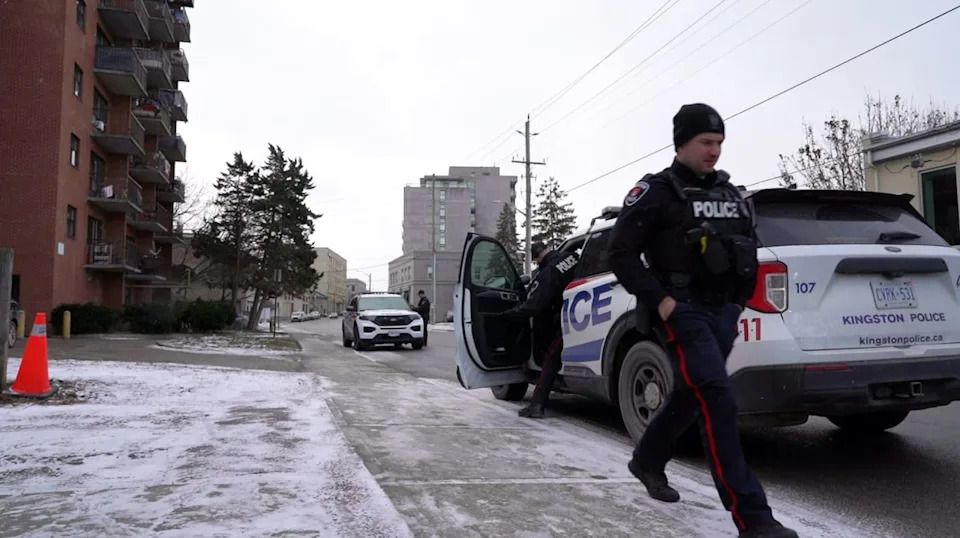 Kingston Police officers leave 381 Bagot Street in Kingston, Ont. on Dec. 4, 2025. The building logged more calls for service from police than any other residential address in the city this year.