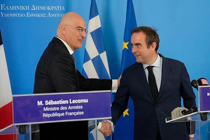 Greek Defence Minister Nikos Dendias and his French counterpart Sébastien Lecornu shake hands during a press conference in Athens, 14 April, 2025