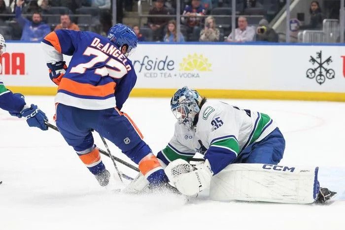Thatcher Demko of the Vancouver Canucks makes a save on Tony Deangelo of the New York Islanders during the second period of the NHL game at UBS Arena on Dec. 19, 2025, in Elmont, New York.