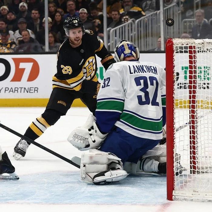 Elias Lindholm of the Boston Bruins fires a shot off the crossbar on Kevin Lankinen of the Vancouver Canucks during the first period at TD Garden on Dec. 20, 2025 in Boston.