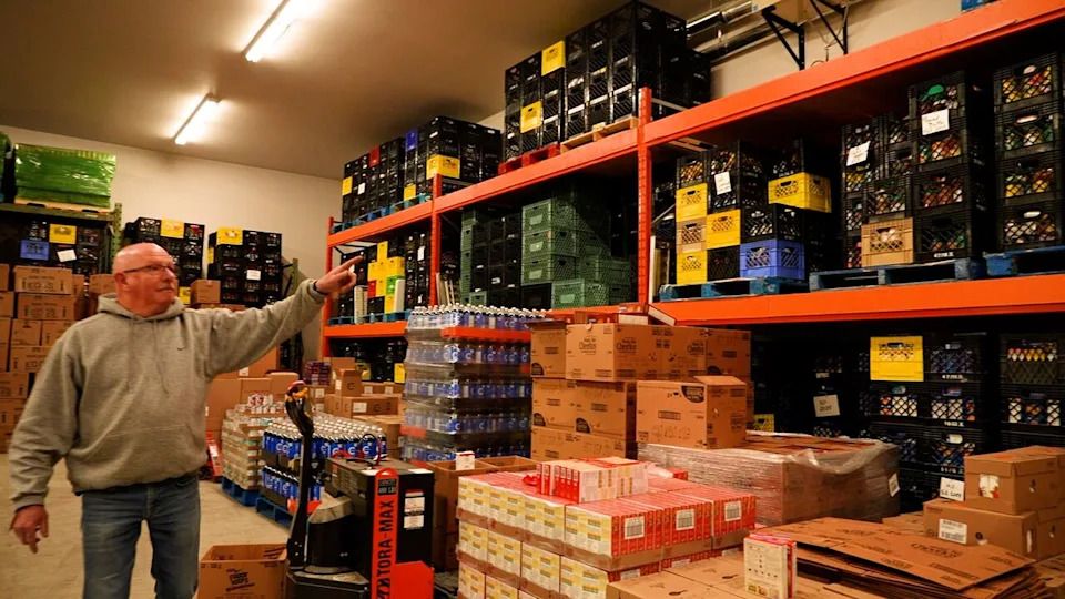 South East Helping Hands executive director and operations manager Ken Dyck points to the warehouse full of food in Steinbach that feeds nearly 400 families every two weeks.