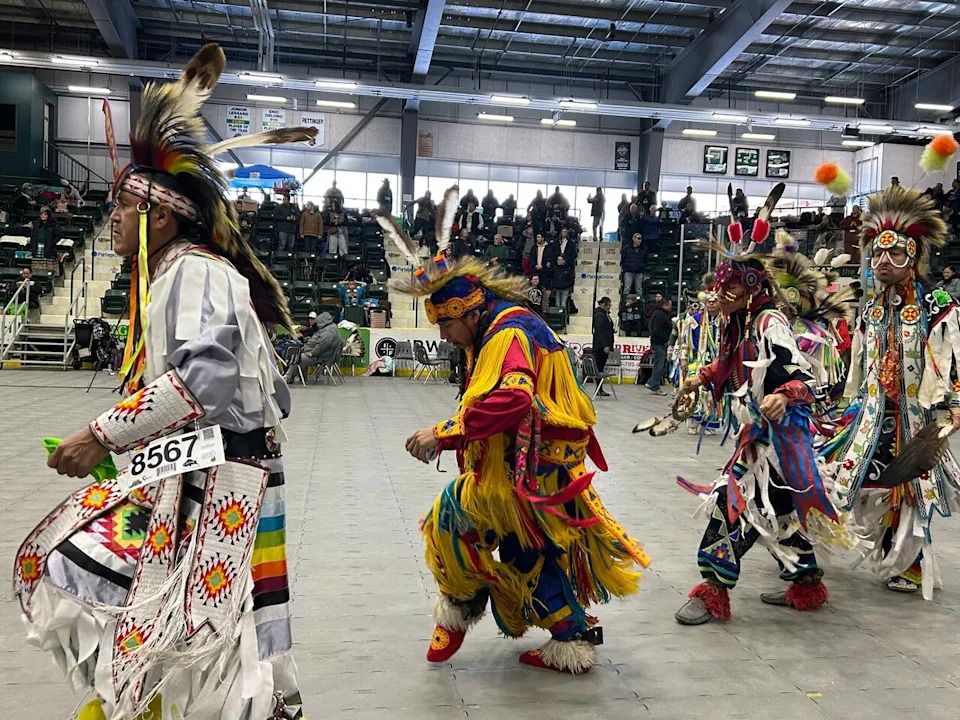 Powwow dancers on the floor of the arena during the Prairie Unity Competition Powwow at Stride Place in Portage la Prairire, Man., on Saturday, Dec. 20, 2025.