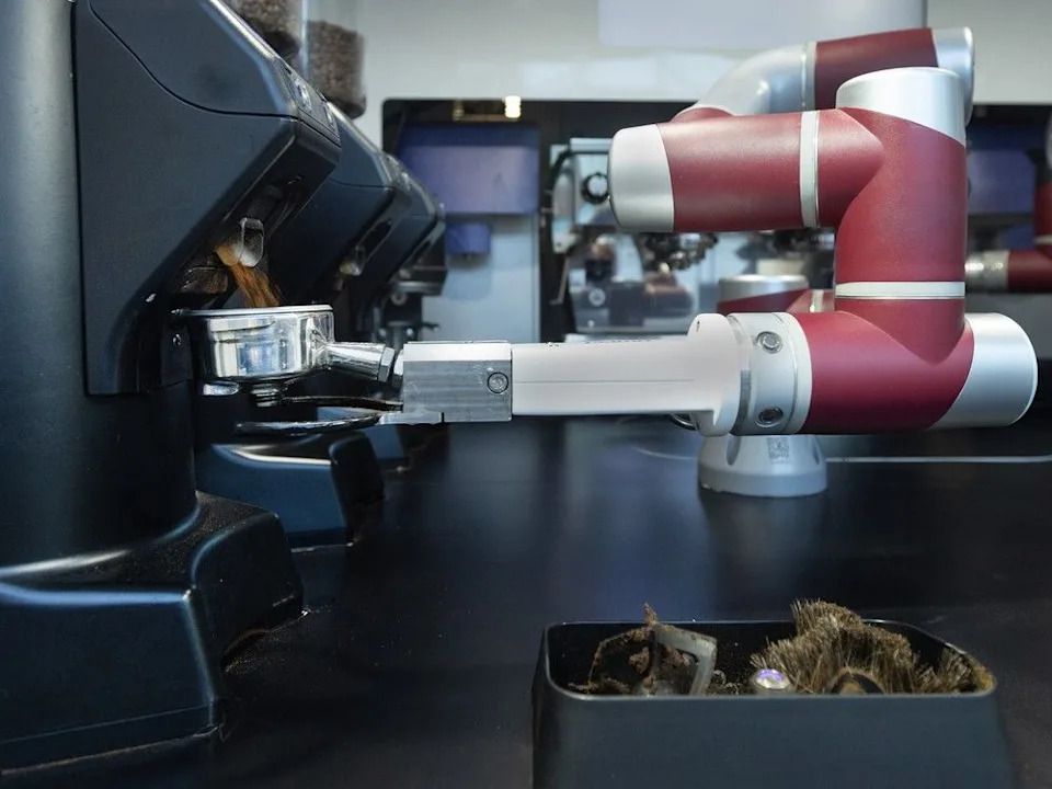 Caffeo’ all-arms robot fills a basket with fresh grounds.