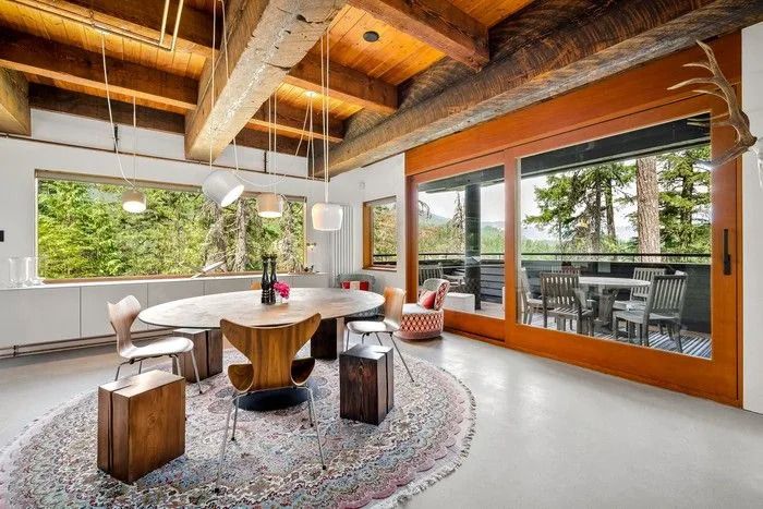 Warm wood accents and Bocci lights create a stylish and cosy vibe throughout the home.