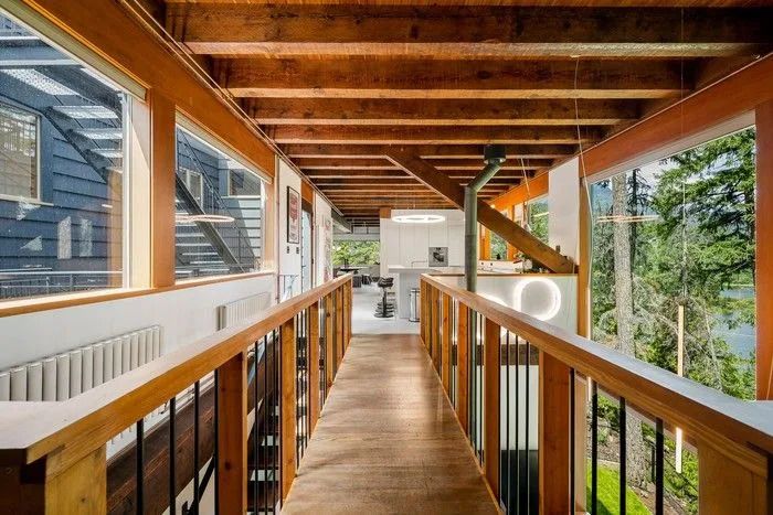 A suspended catwalk leads from the main entrance over the office and into the kitchen.