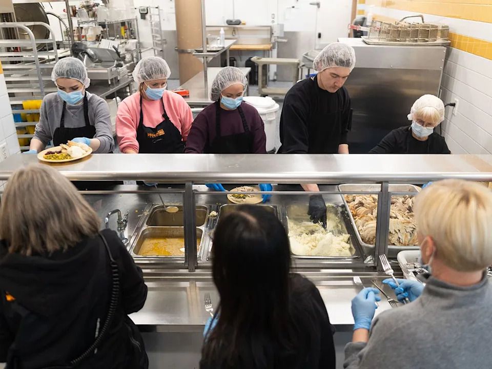 Volunteers serve up meals of turkey at the Calgary Drop-In Centre on Christmas Day, Thursday, Dec. 25, 2025.