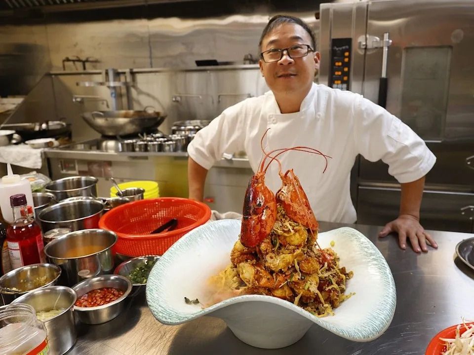 At 99 VIP Seafood Restaurant, chef-owner Kevin Tan prepares a showy lobster dish.