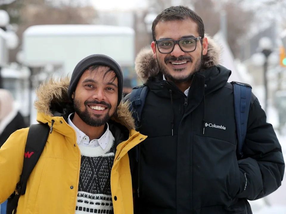 Amit Biswas, left, and Wriju Ghosh decided last-minute to take a bus to Ottawa for Christmas.