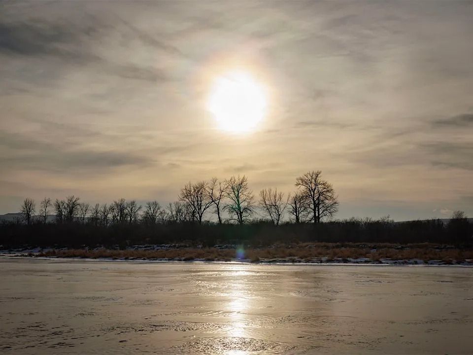 The winter sun heads for the horizon over the Bow River near Carseland, Ab., on Tuesday, Dec. 23, 2025.