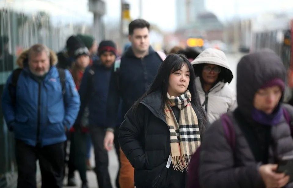 Commuters come and go from the Tunney’s Pasture LRT station.