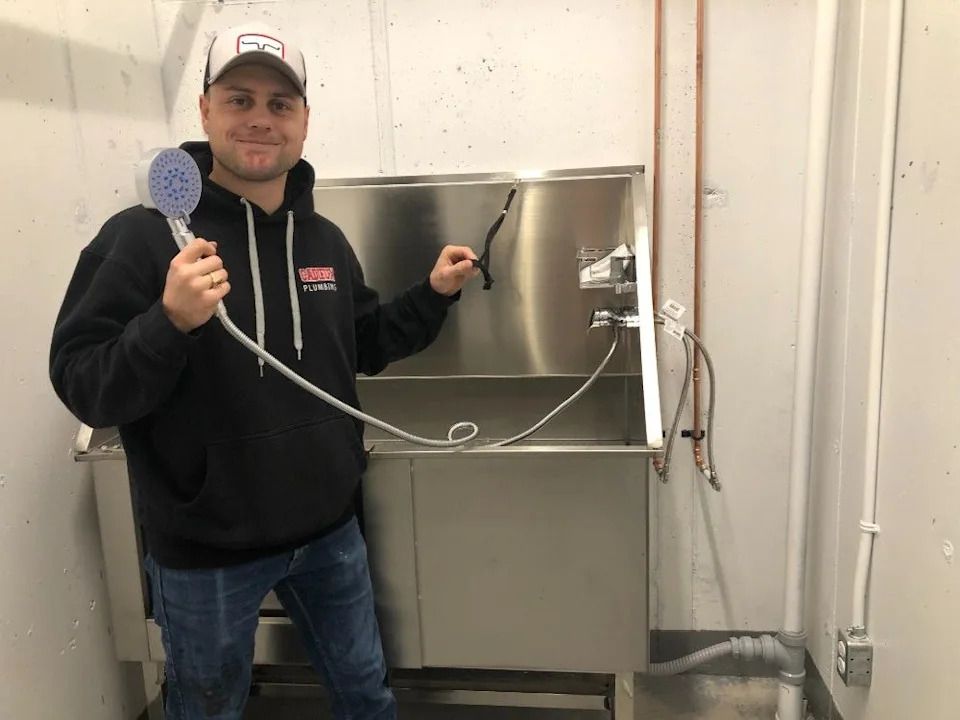 One of the site supervisors, Andrew Gelineau hooks up the pet wash.