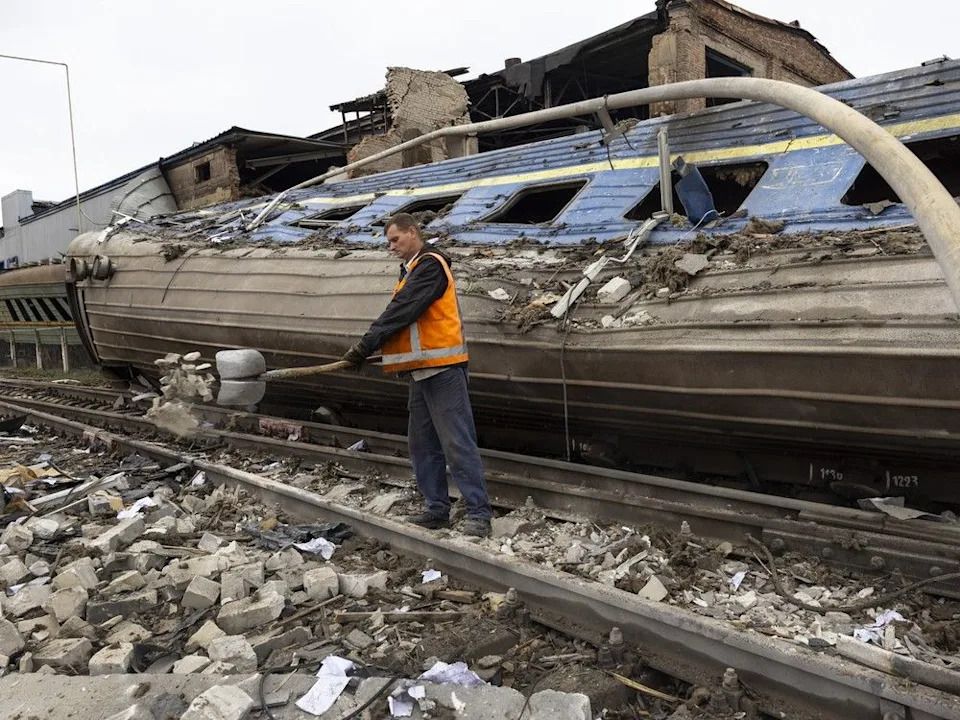 Workers clear debris from a train depot that was hit by missiles overnight on September 28 2022 in Kharkiv, Ukraine.The attack also hit a power plant knocking out electricity to 18,000 residents of Kharkiv.