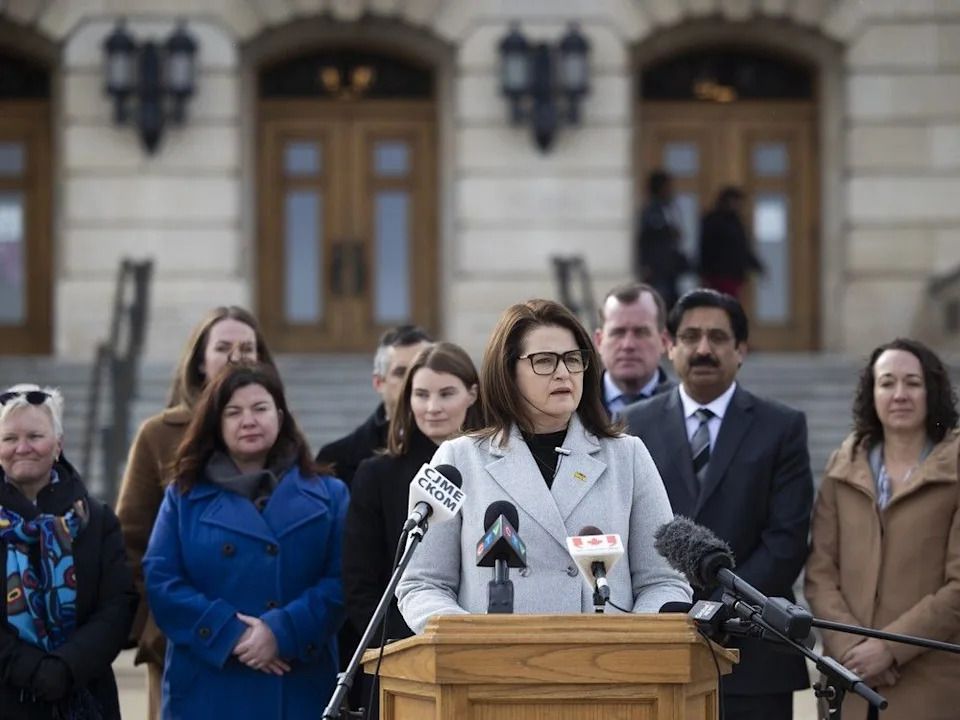 NDP Leader Carla Beck speaks outside the Saskatchewan Legislative Building, with her NDP colleagues behind her, to address U.S. tariff threats on March 4, 2025 in Regina.