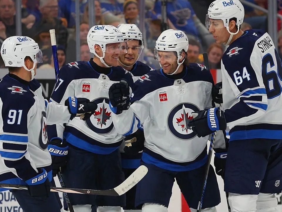 Colin Miller #6 of the Winnipeg Jets celebrates with teammates after scoring a goal against the St. Louis Blues in the second period at Enterprise Center on October 22, 2024 in St Louis, Missouri.