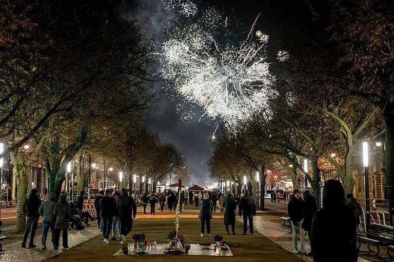People gather near the Brandenburg Gate to celebrate and watch the fireworks for the New Year's celebrations in Berlin, 31 December, 2024