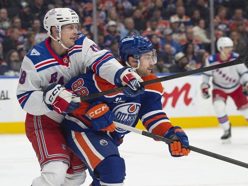 Andrew Mangiapane (88) of the Edmonton Oilers, gains position in front of the net from Urho Vaakanainen (18) of the New York Rangers at Rogers Place in Edmonton on Thursday, October 30, 2025.