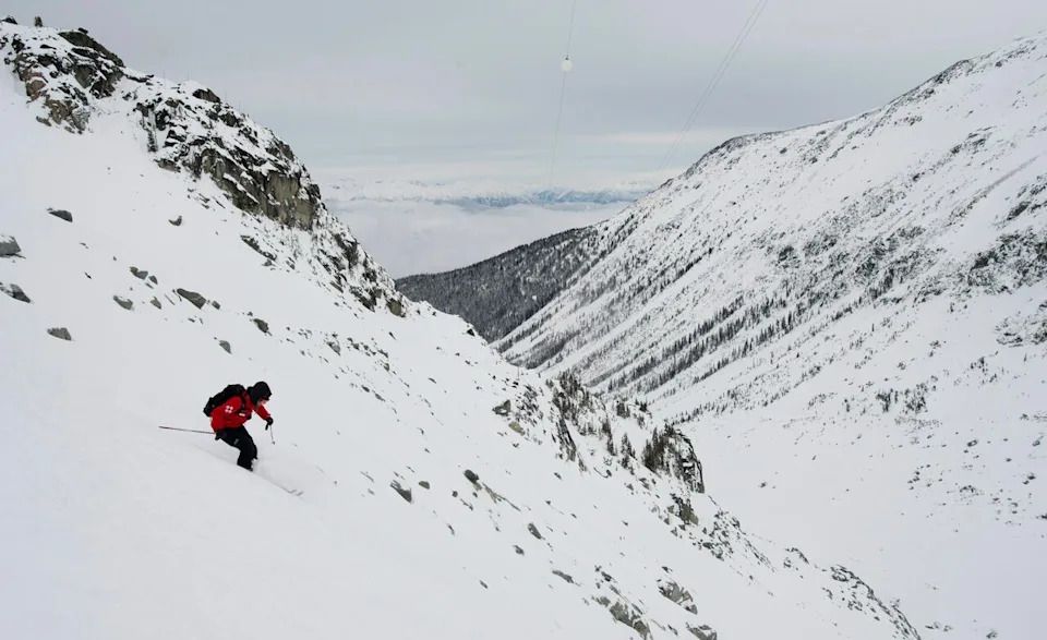 Blackcomb mountain ski patroller Nicole Koshure inspects a ridge on Blackcomb Mountain in Whistler, B.C., early morning Friday, December, 21, 2012. Some 30 Blackcomb mountain patrollers look after 3,414 acres of terrain on a daily basis making sure that the ski hill is safe each day for skiers of all levels. To date the hill has received over 513cm of snow for the season.