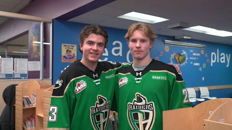 Riley Boychuk, left, and Ben Harvey took an evening away from the ice to read books to children in Prince Albert.