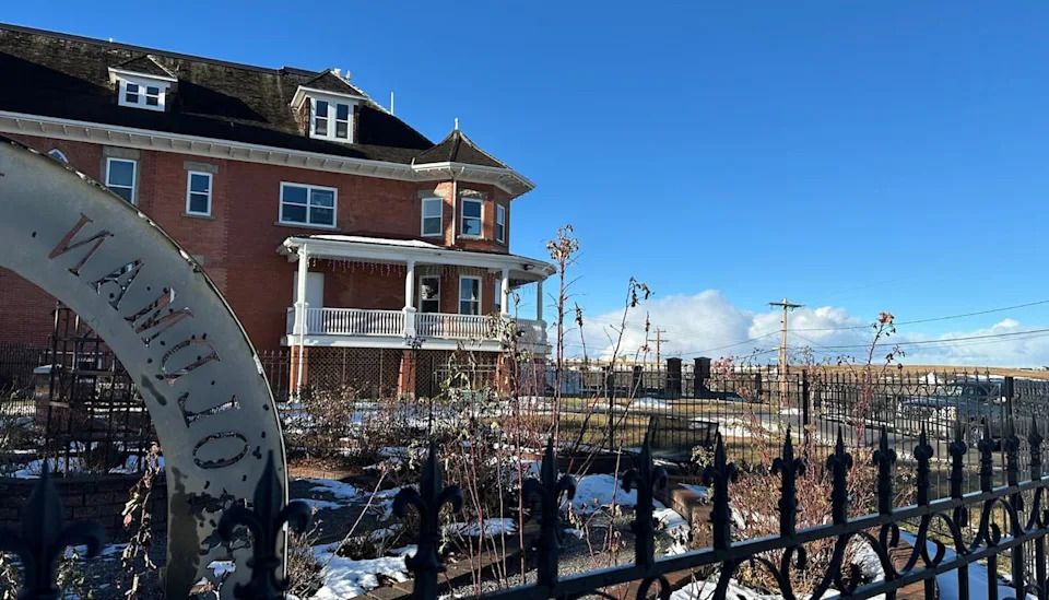 An audience sits in the rose garden and across the east lawn during the Lebel Mansion outdoor concerts.
