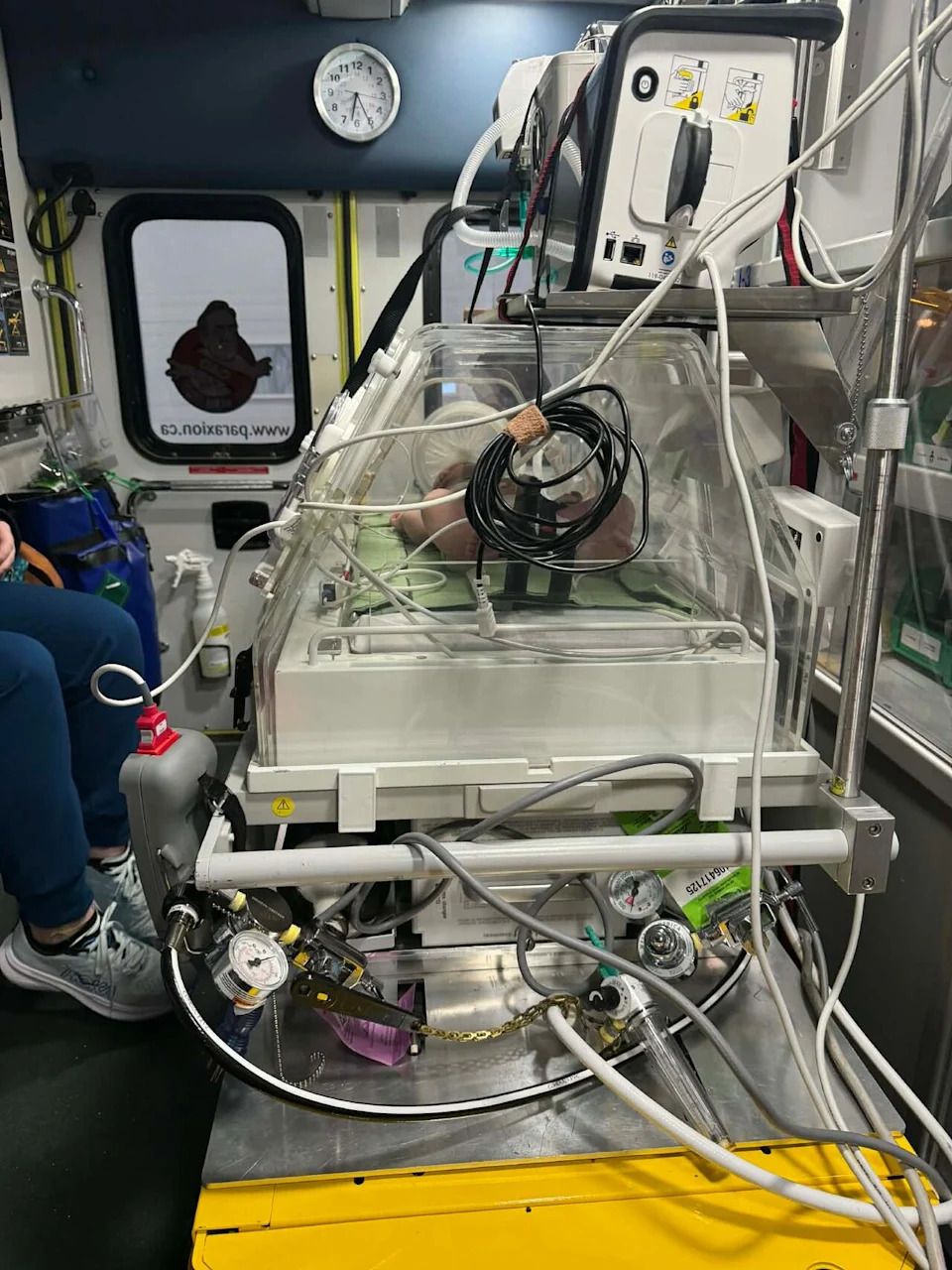 Camille Arsenault's daughter is transported by ambulance back to Maria, after her birth in a Chandler hospital.