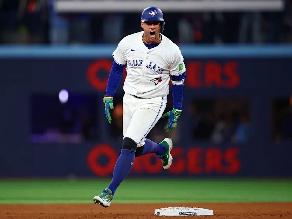 George Springer of the Toronto Blue Jays celebrates after hitting a three-run home run against the Seattle Mariners during Game 7 of the ALCS.
