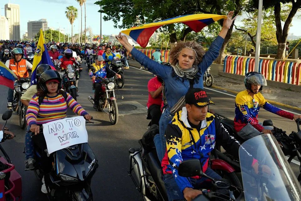 Government supporters ride motorbikes through Caracas, Venezuela, Monday, Dec. 22, 2025, to protest U.S. interference.