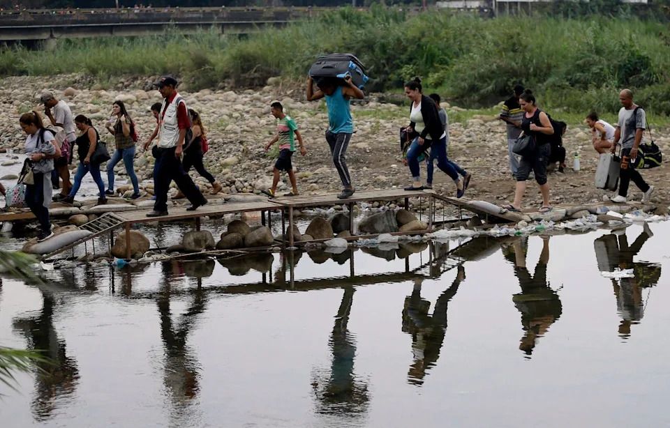 In this April 14, 2019 file photo, Venezuelans cross illegally into Colombia near the Simon Bolivar International Bridge, close to Cucuta, Colombia. The U.N. refugee agency said Friday, June 7, that the number of Venezuelans who have left their country in recent years has surpassed 4 million.