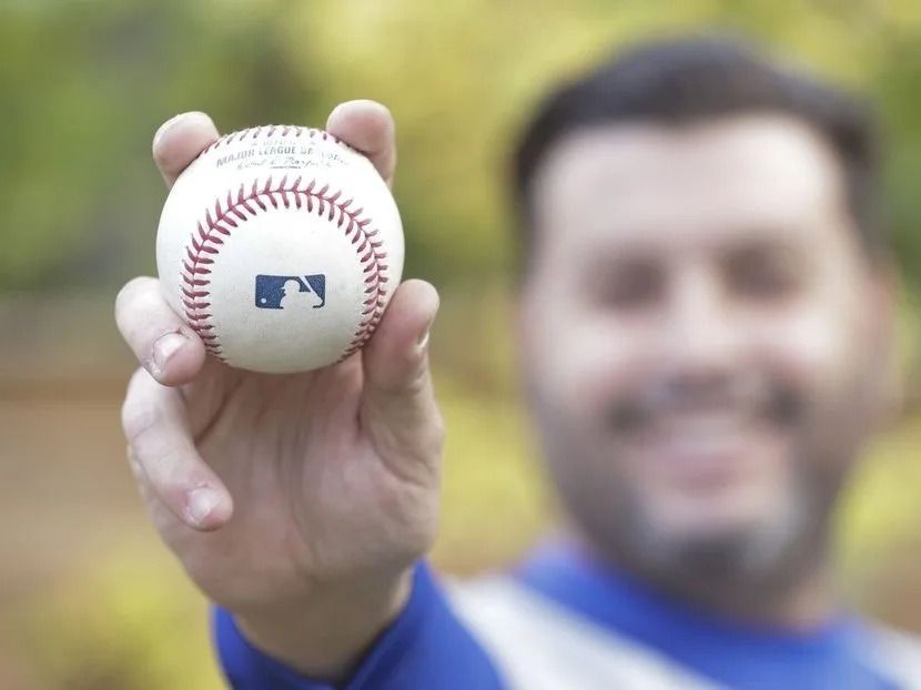 Toronto Blue Jays fan Michael Angeletti poses in his Etobicoke backyard with the George Springer 3-run home run ball that he caught in the the seventh inning of Game 7 of the ALCS championship. The home run won the game and the series for the Blue Jays. on Tuesday October 21, 2025. Jack Boland/Toronto Sun/Postmedia Network