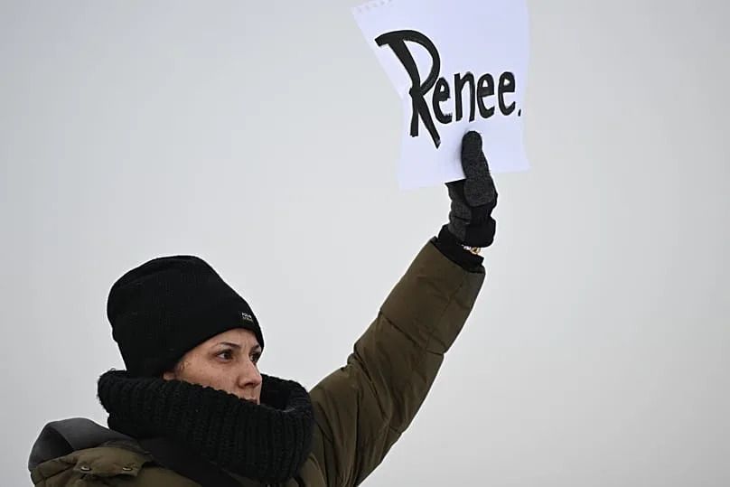 A protesters holds up a sign reading "Renee" in Minneapolis, 8 January, 2026