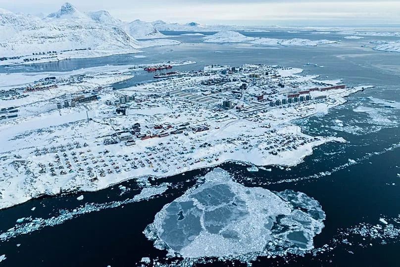Houses covered by snow are seen on the coast of a sea inlet of Nuuk, Greenland, 7 March 2025