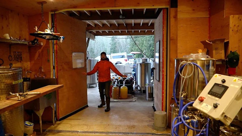 Colin Rombough stands in the building that was added to the property that led to the reclassification, which is used to process the apples from the farm and turn them into cider.