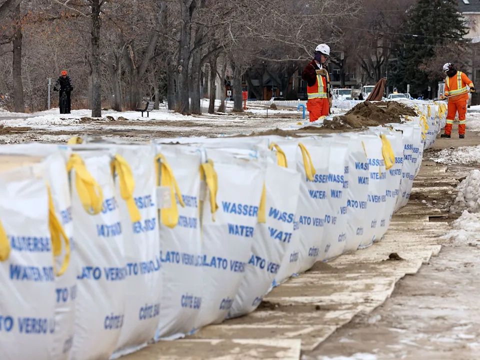 A flood barrier is placed along the Bow River Pathway in Parkdale to protect the community from flooding in the event of another break in Calgary’s Bearspaw South feeder main. Barrier construction is seen here on Saturday, Jan. 10, 2026.