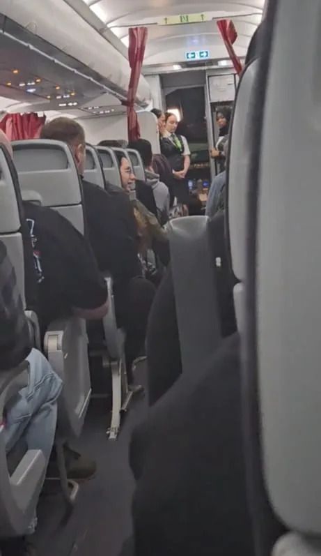 An image taken by Gabrielle Caron at the moment the Air Canada pilot announced there was a crew member in the baggage hold. Concerned flight attendants are visible standing by the cabin door.