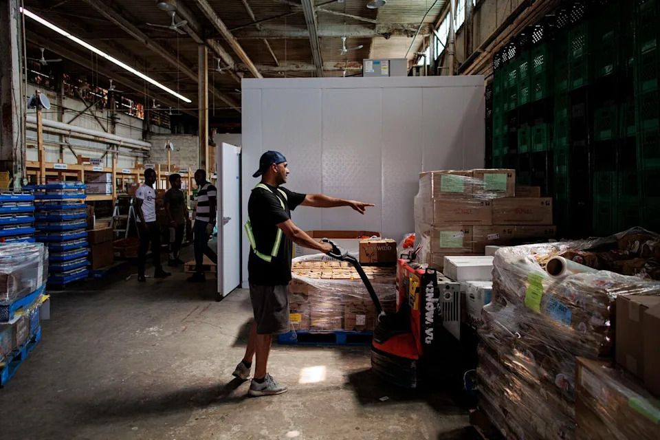 Volunteers and staff with the Feed Scarborough Food Bank unload donations at the charity’s warehouse on Aug. 3, 2023.